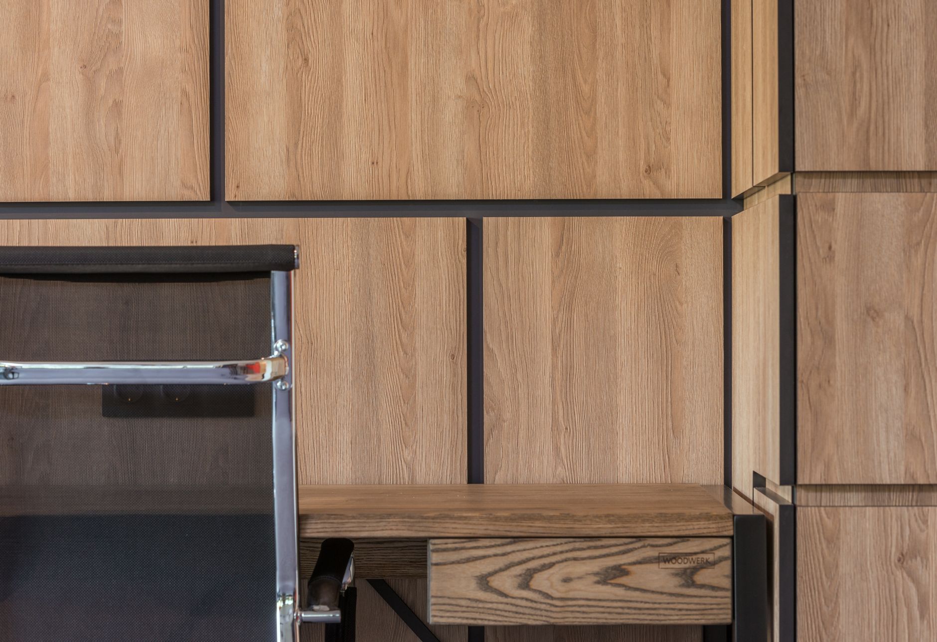 Wood cabinetry and a compact studio desk