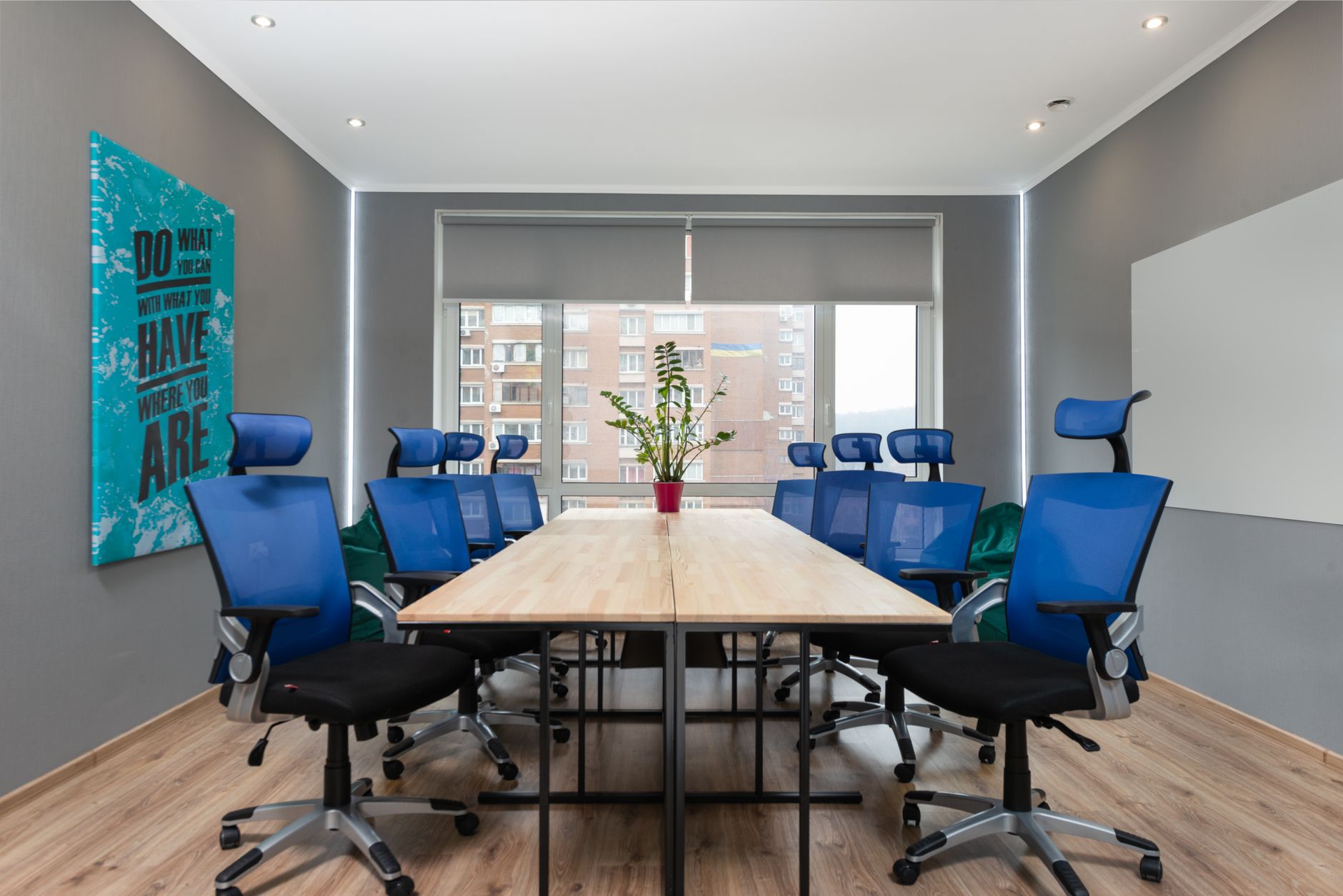 Studio meeting room with a long table and blue chairs